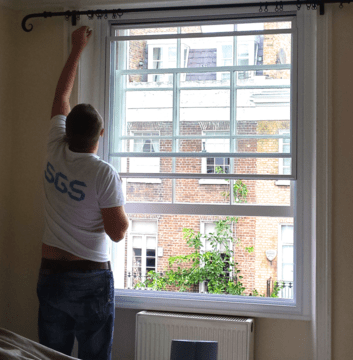 Professional SGS installer fitting secondary glazing in London home